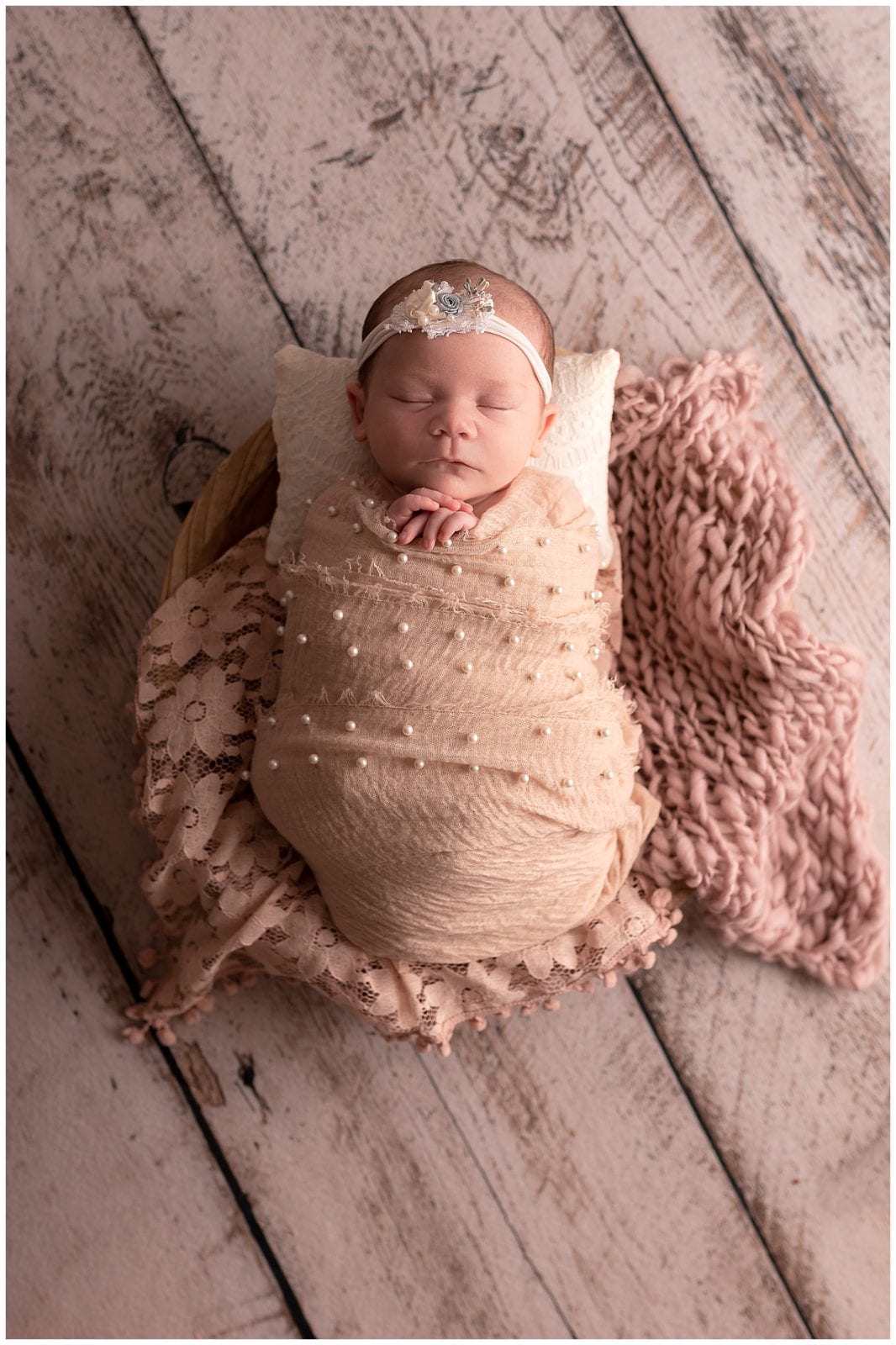 A wrapped newborn photo by Hello Photography