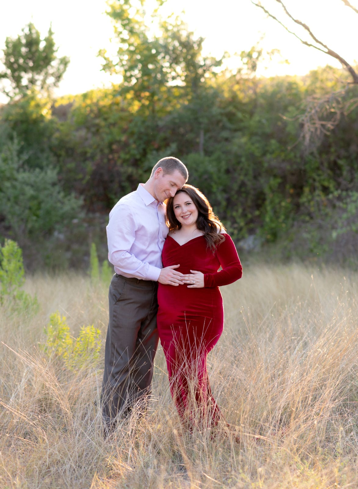 Maternity photos with a red velvet dress.