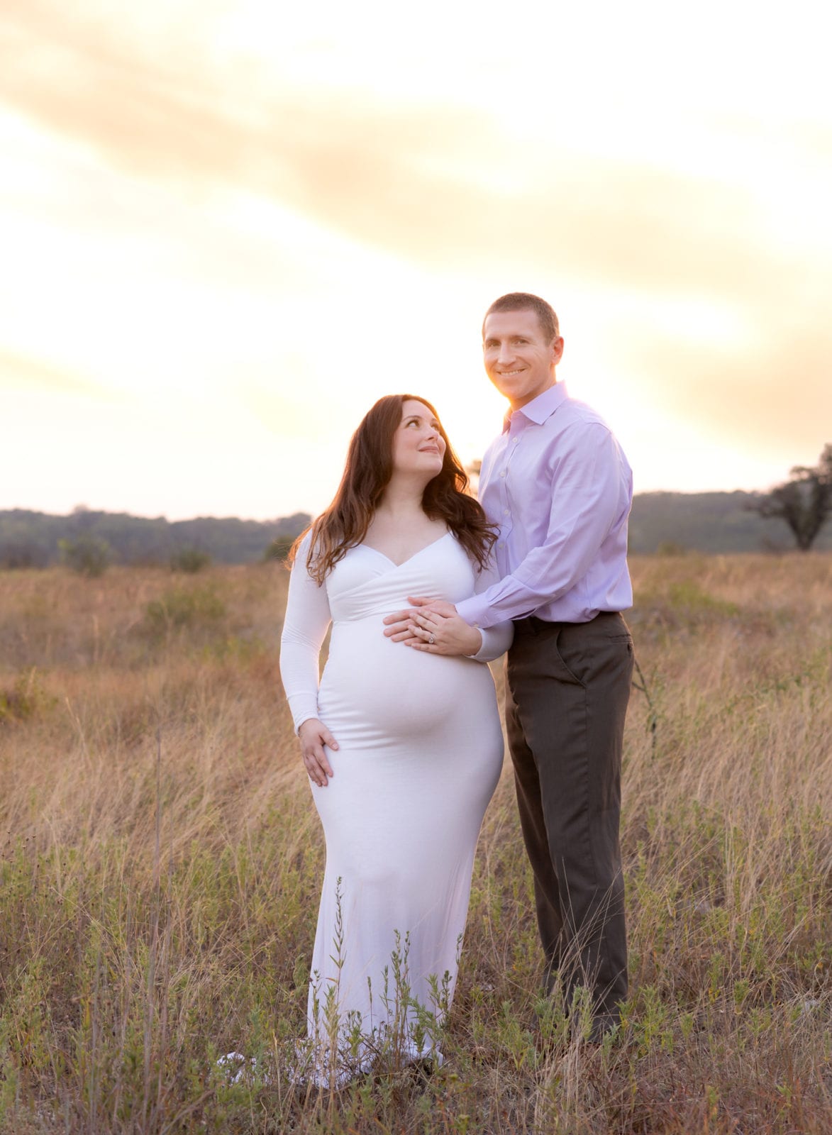 Maternity pics of a couple at sunset