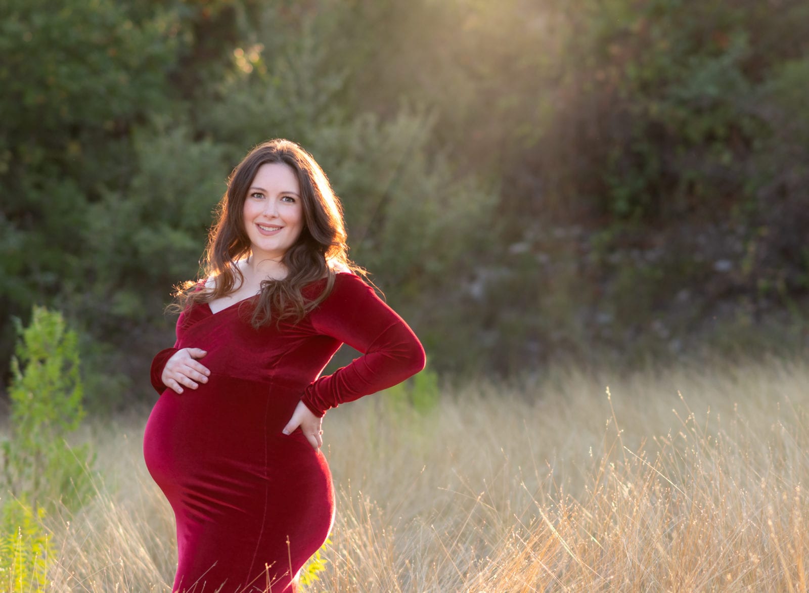 Maternity photos with a red velvet dress.