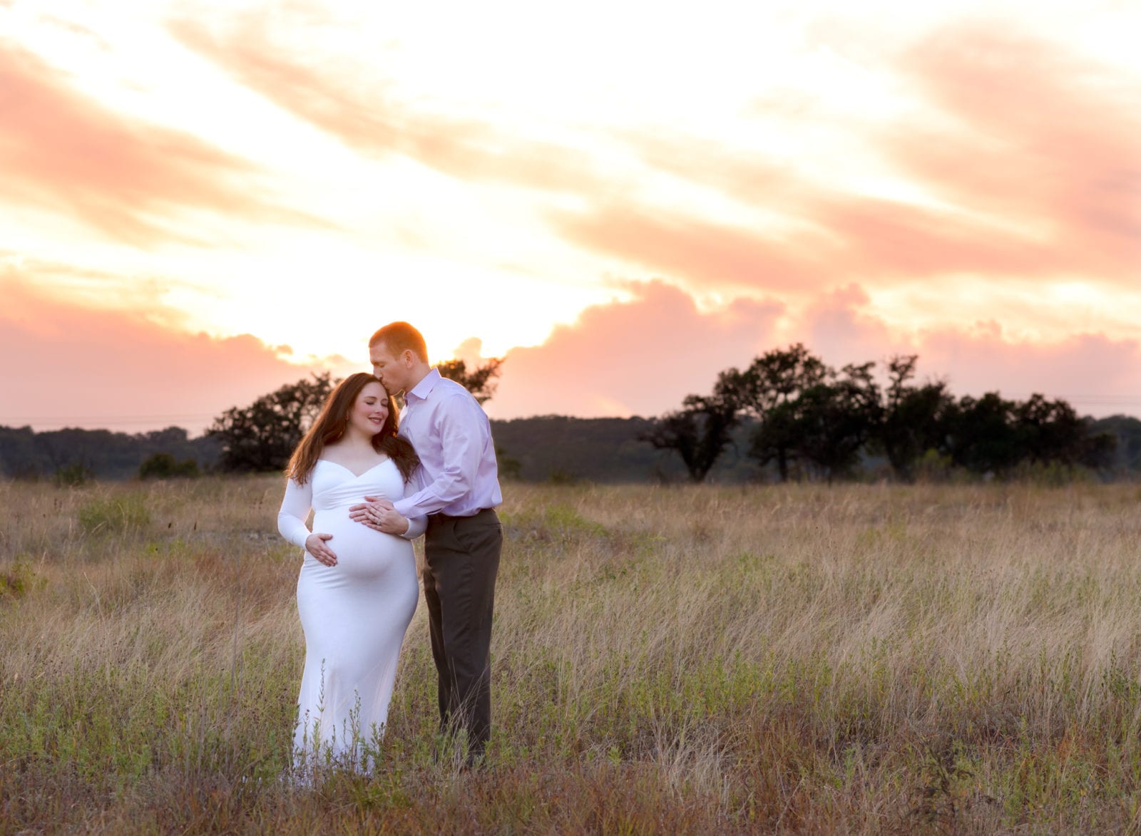 Maternity pics of a couple at sunset