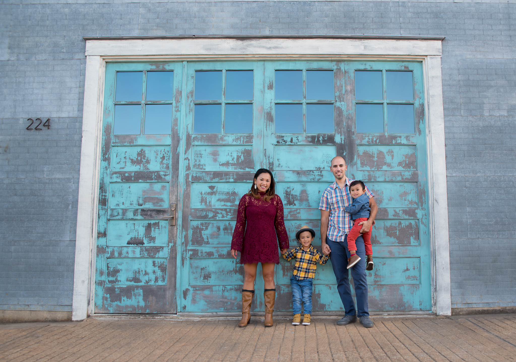Family of four in front of a turquoise door
