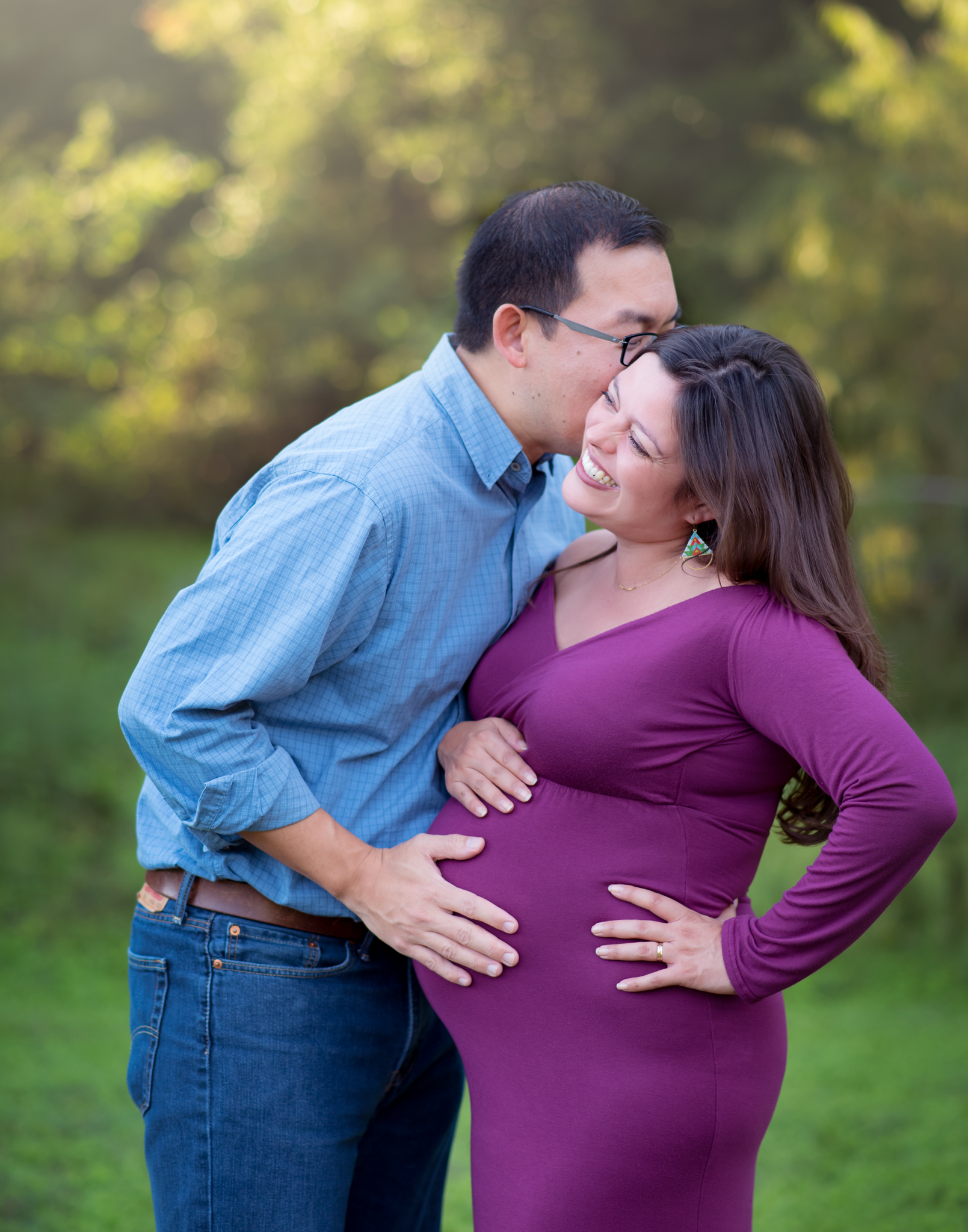 a laughing couple during their maternity session