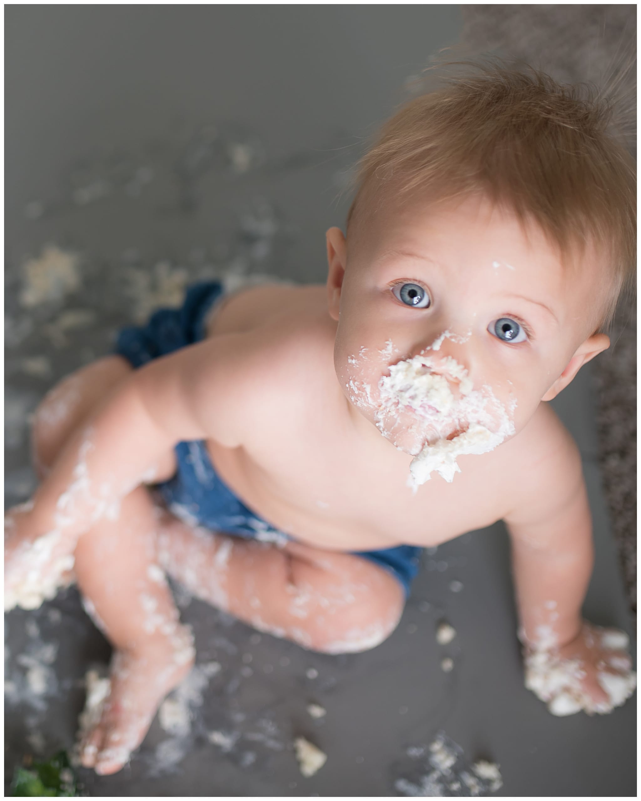 A baby with cake in their face!