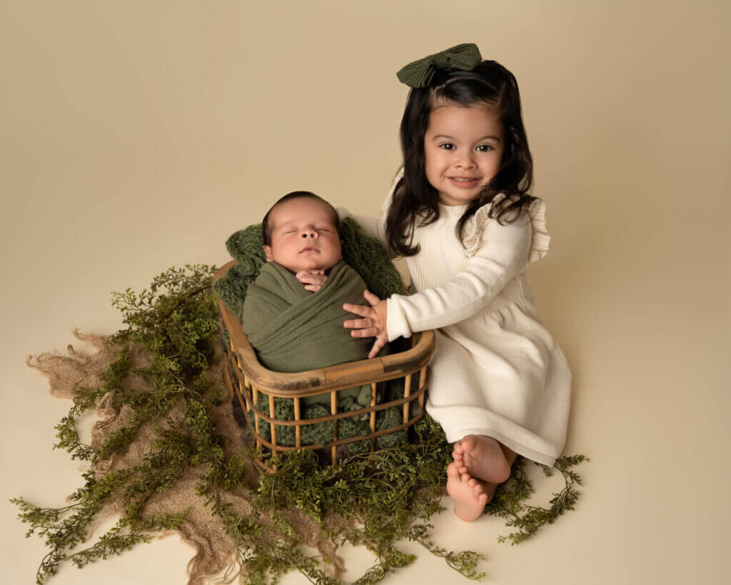toddler girl with baby brother during austin newborn photos