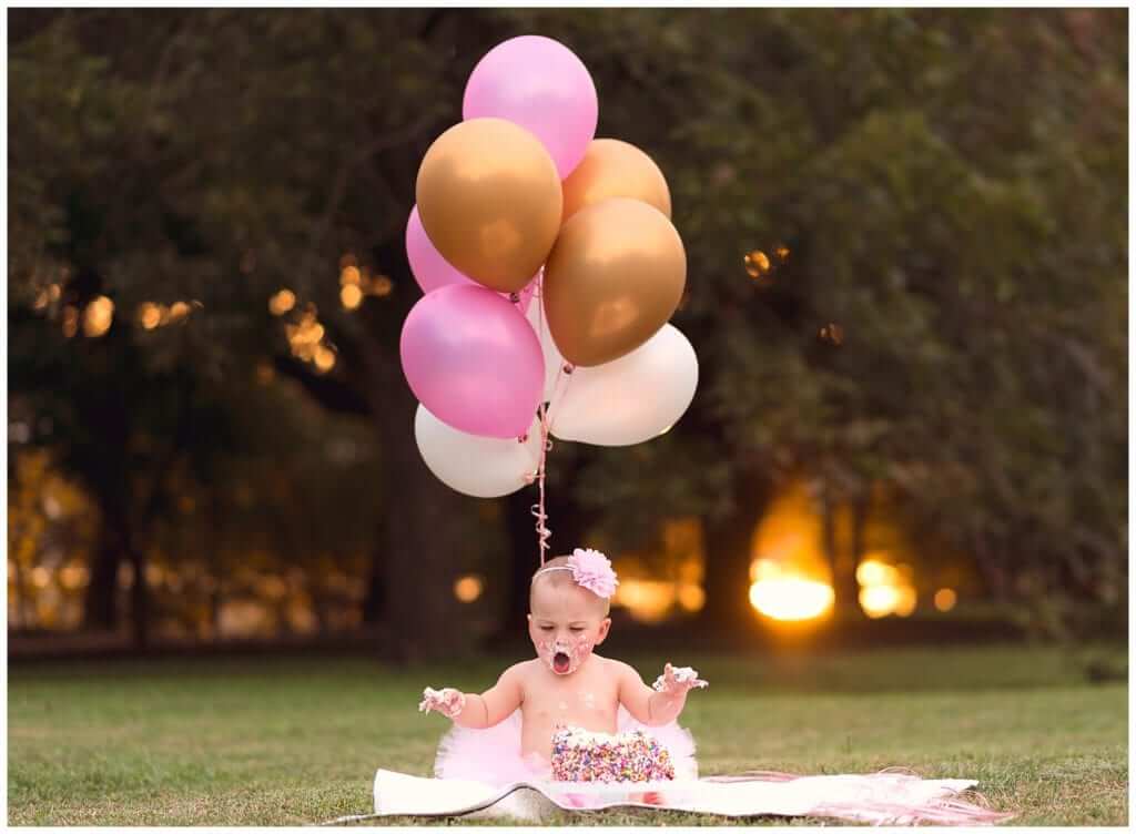Austin cake smash photography outdoor session with pink tutu and balloons in park setting
