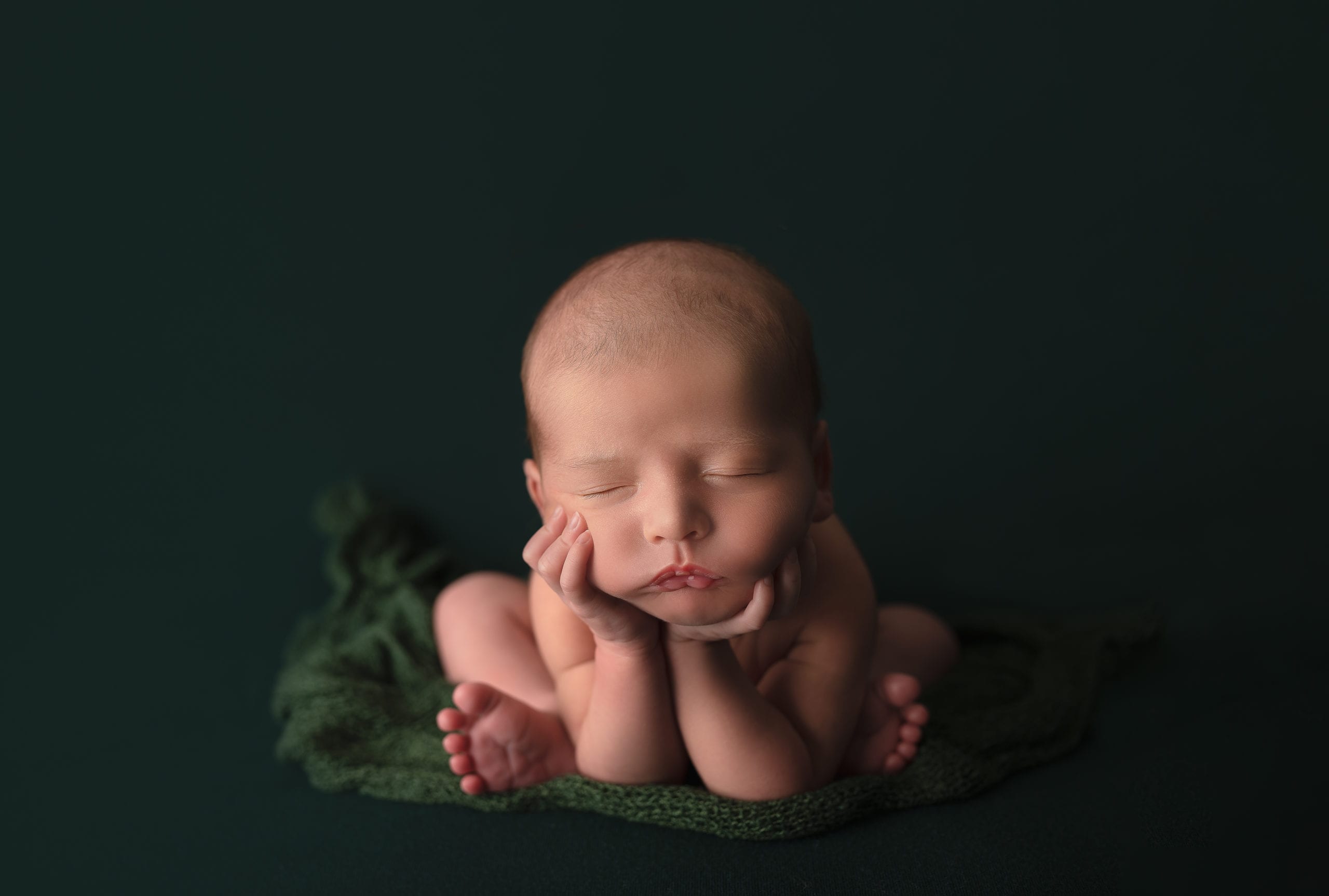 A newborn baby in the froggy pose by Hello Photography