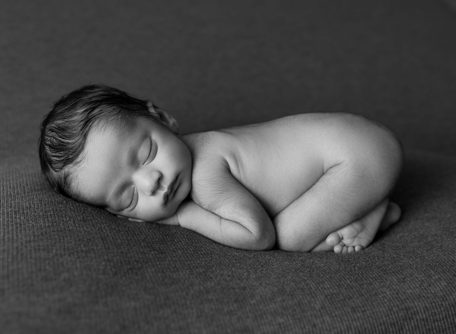 Sleeping newborn baby in black and white by Hello Photography