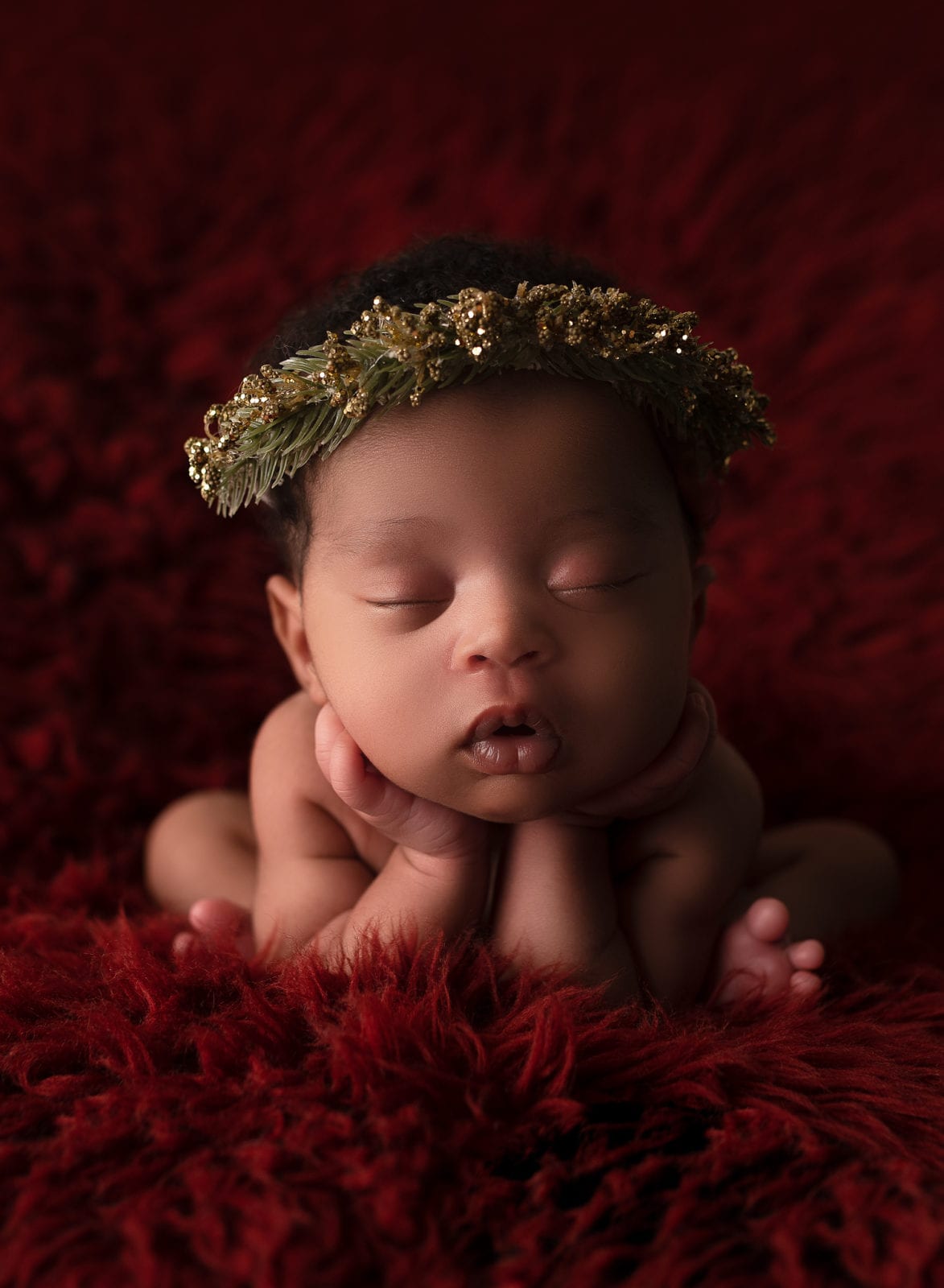 newborn baby photo on a red background