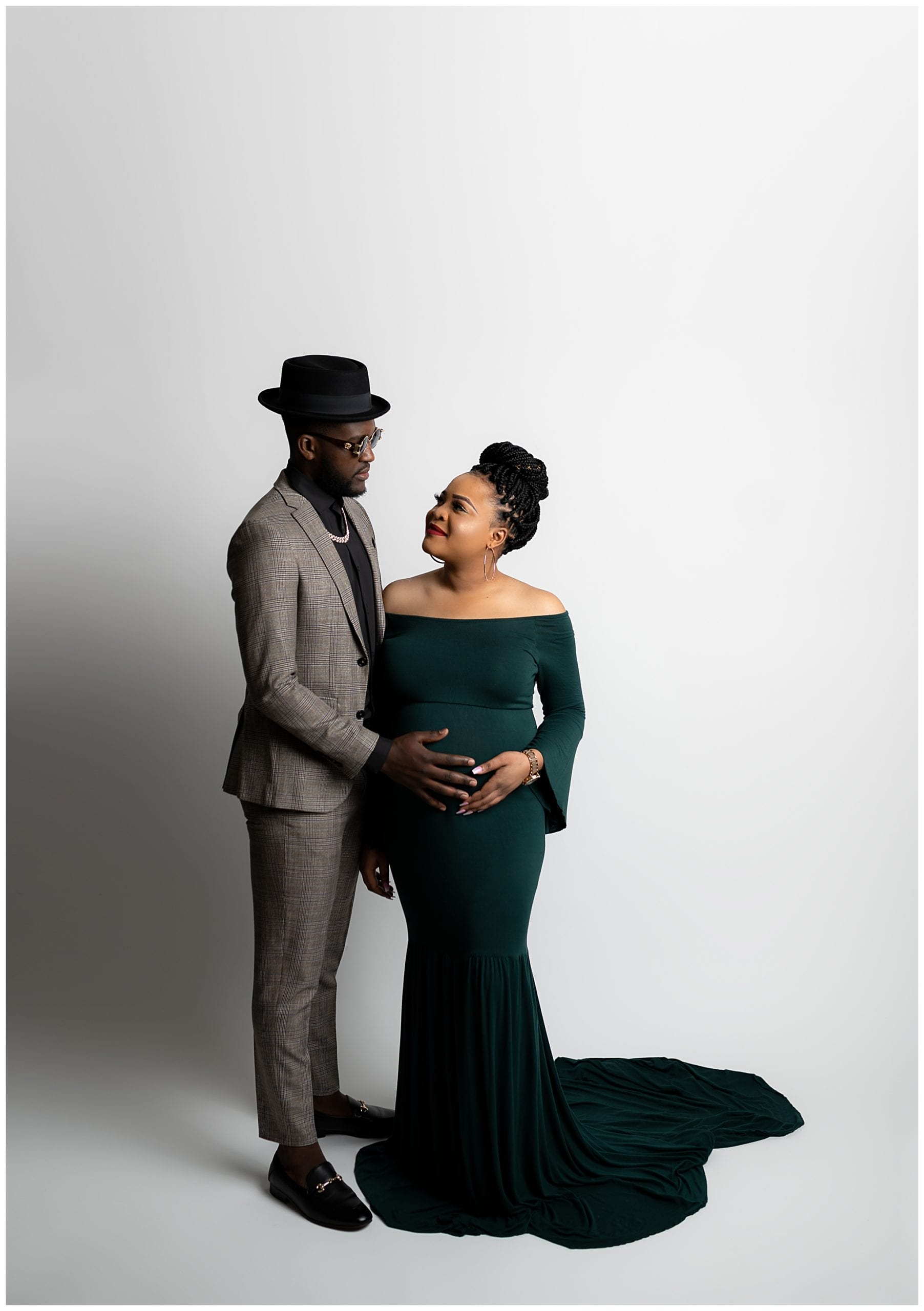 An african-american couple posing for maternity photos in the Austin, Texas studio.
