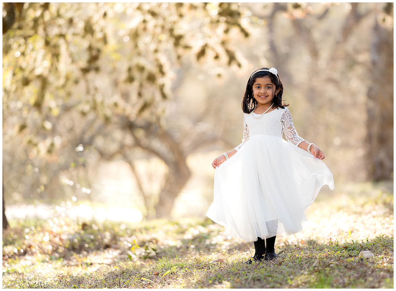 little girl wearing a white dress in pretty sunlight