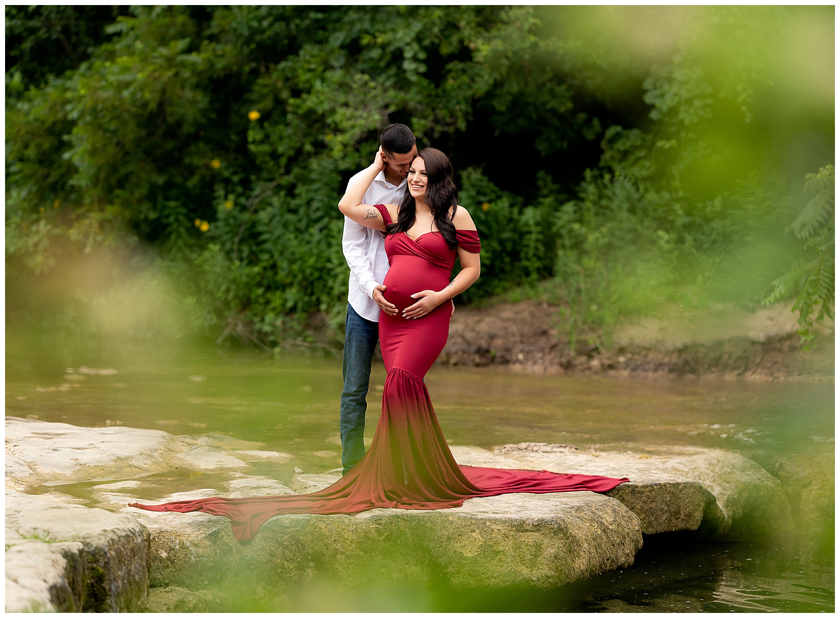 couples maternity photo with the woman wearing a red mermaid dress