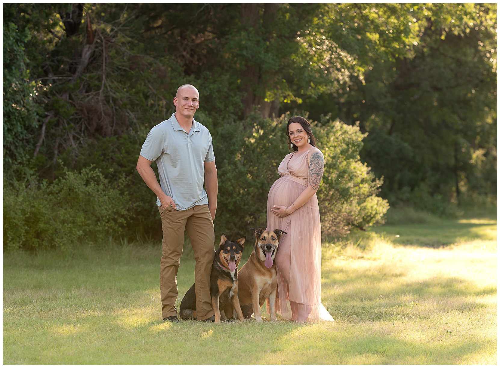 dad and pregnant mom with their dogs