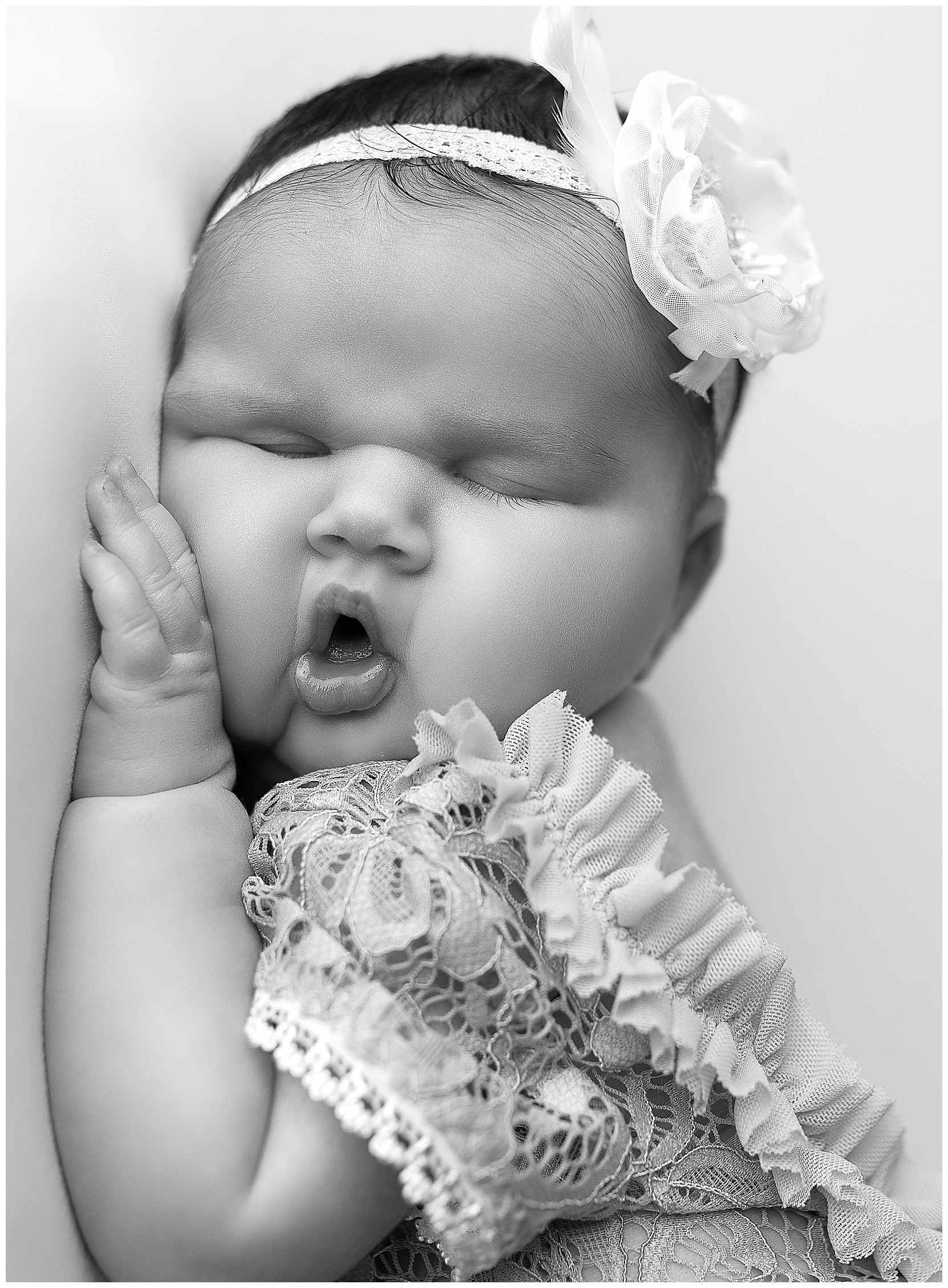 baby girl sleeping with her mouth open on a white blanket