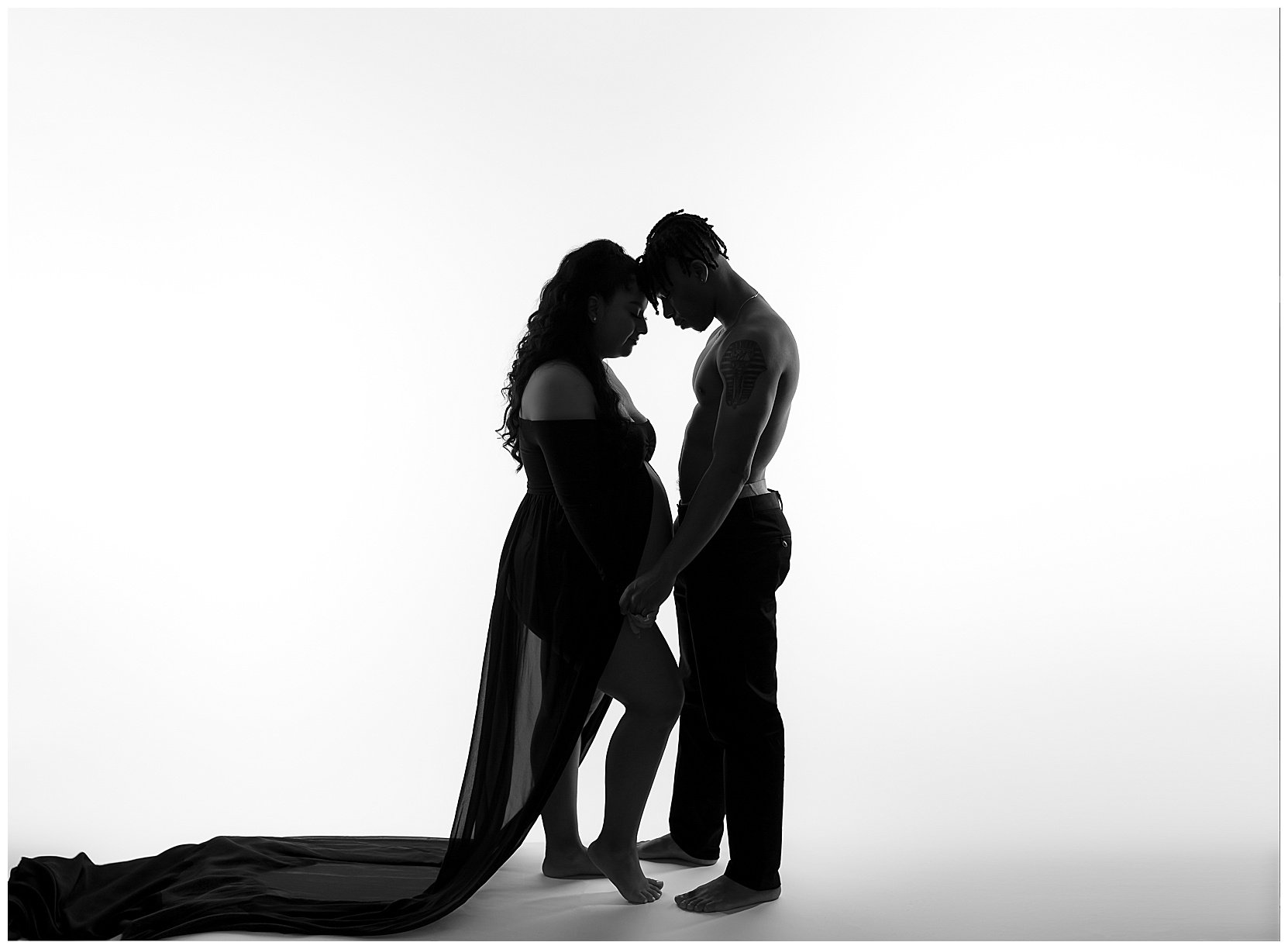 silhouette photo of a pregnant couple
