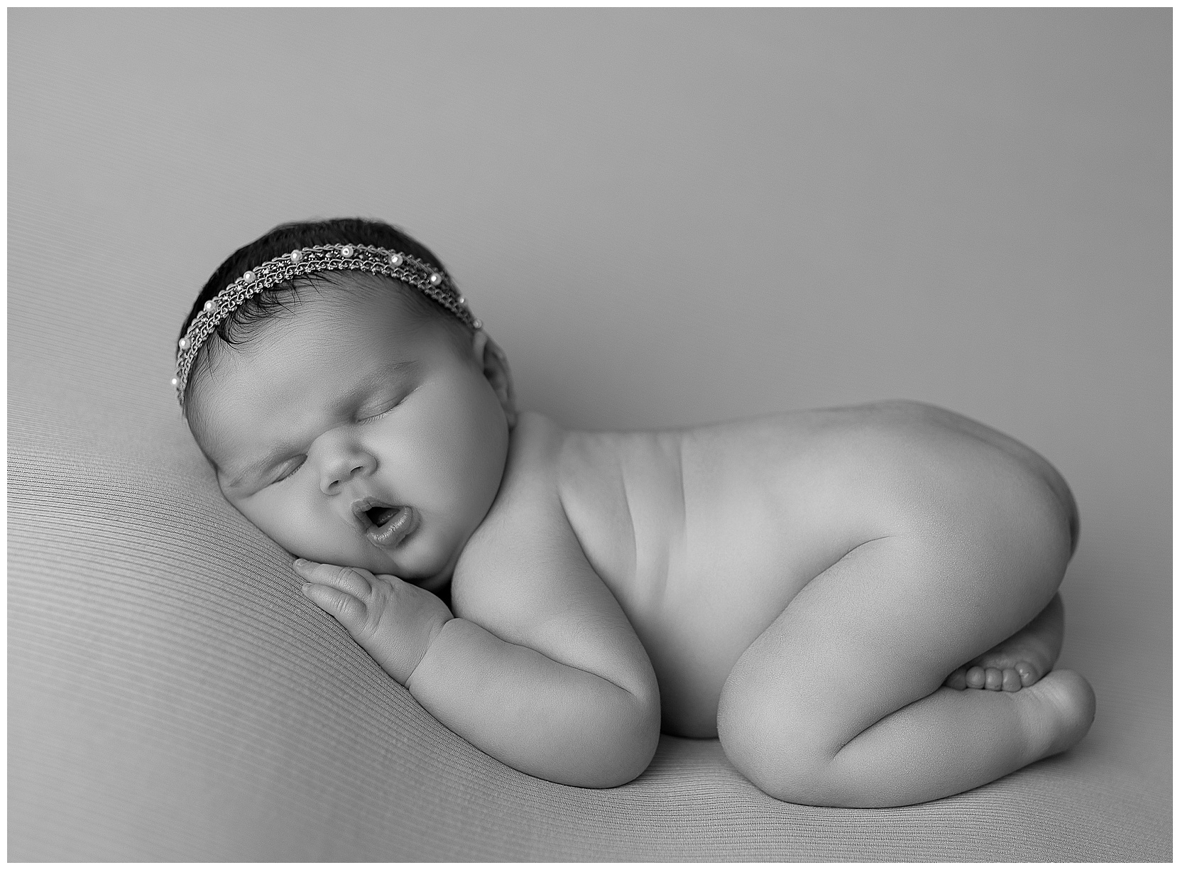 curled up, sleeping baby girl black/white photo