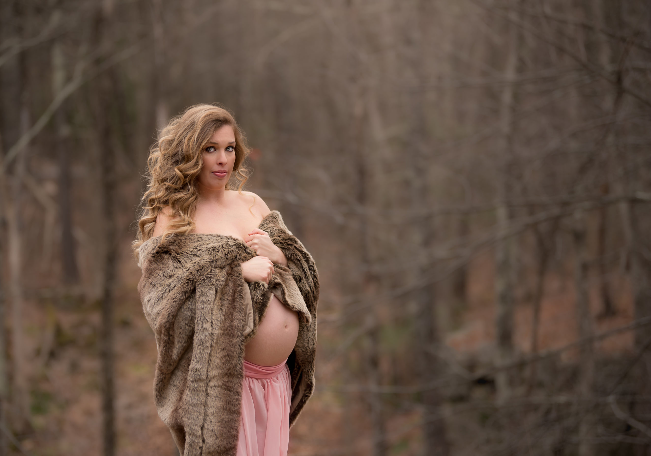 pregnant woman fur coat woods