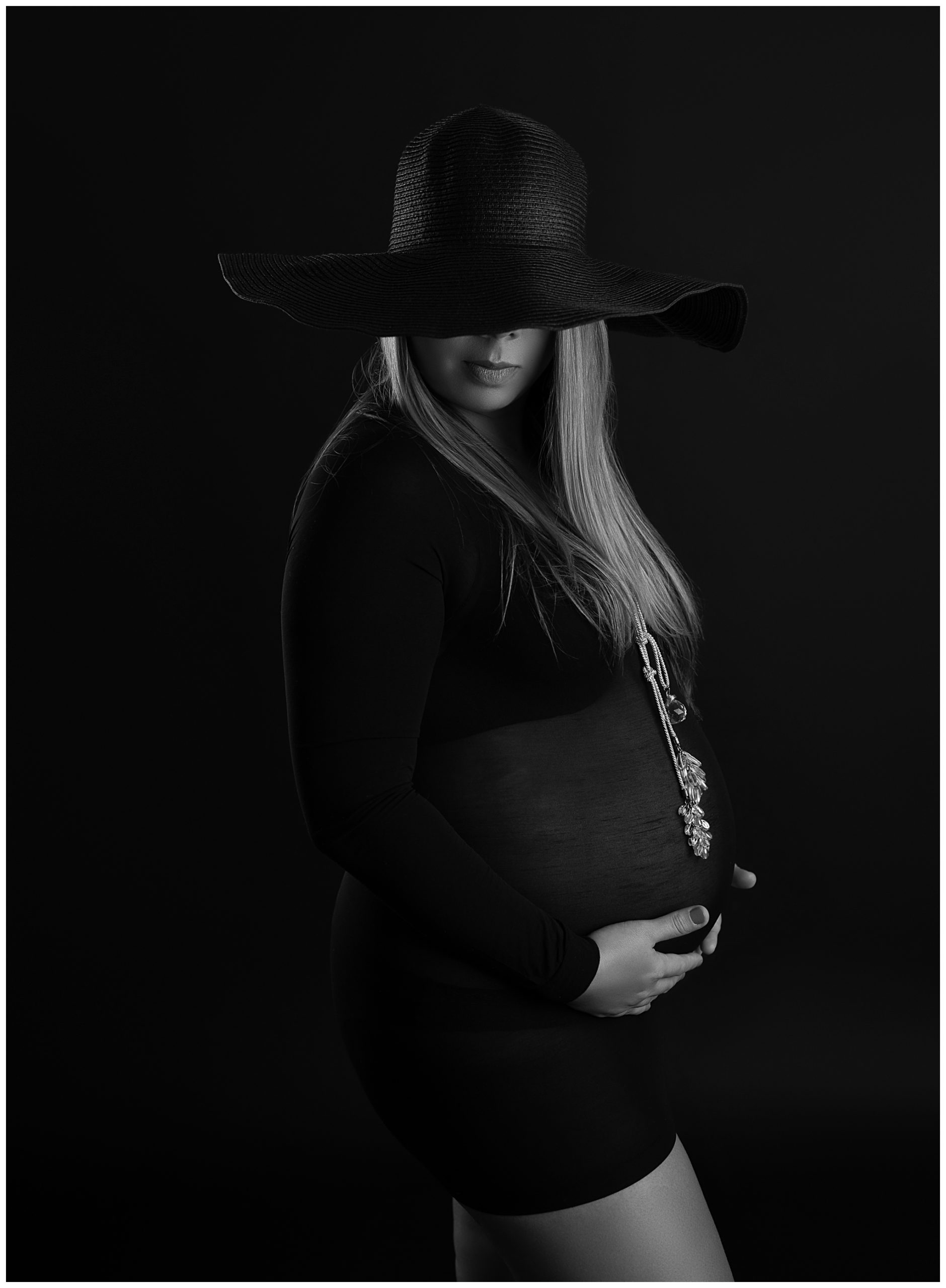 pregnant woman black floppy hat black sheer shirt