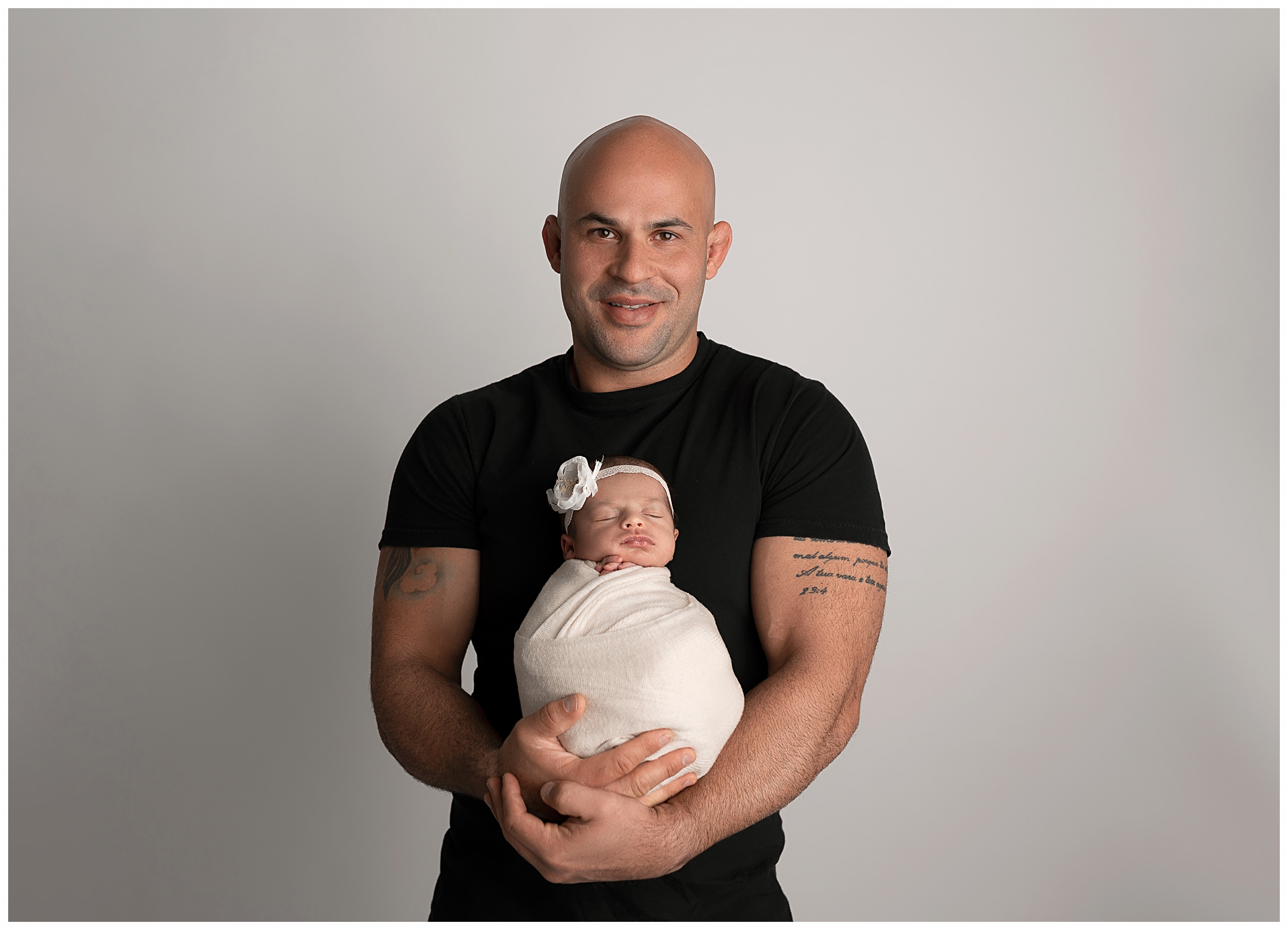 dad black tshirt baby wrapped in white