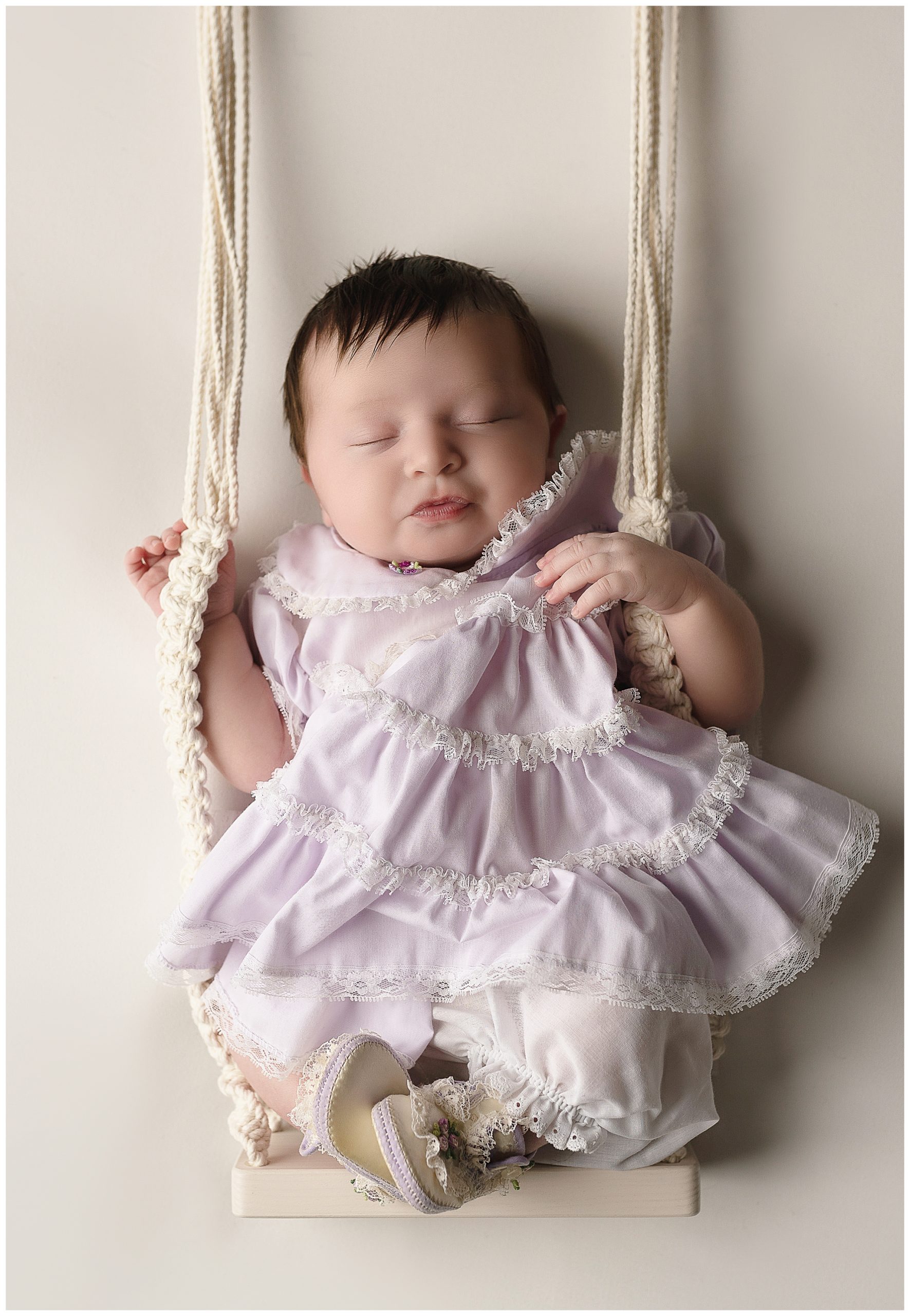 sleeping baby purple dress swing
