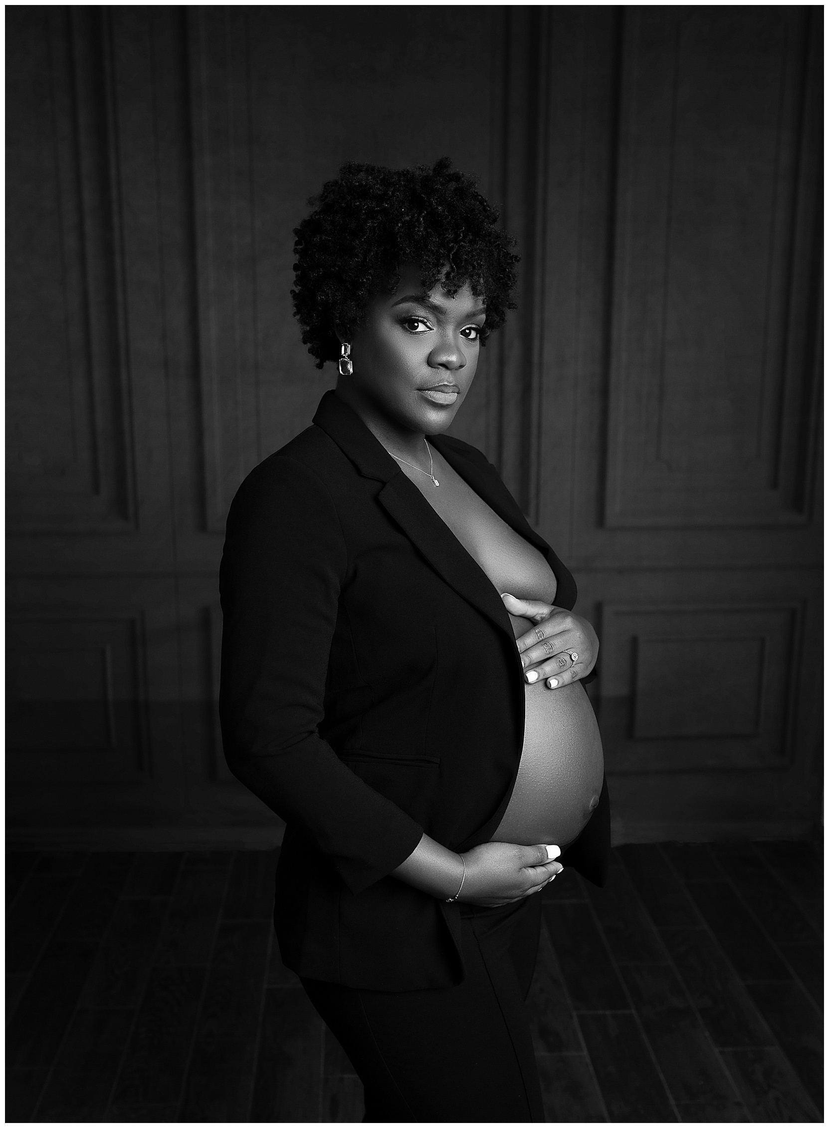 pregnant woman open blazer holding belly