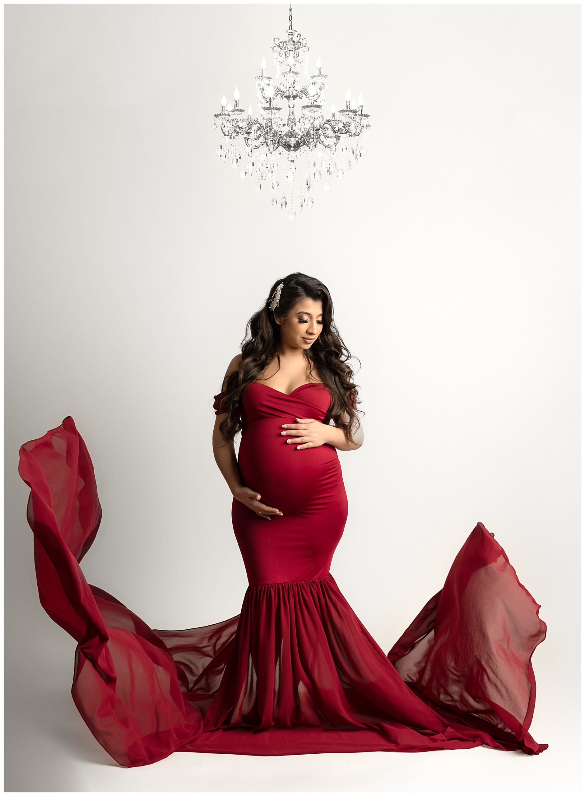 pregnant woman red dress chandelier