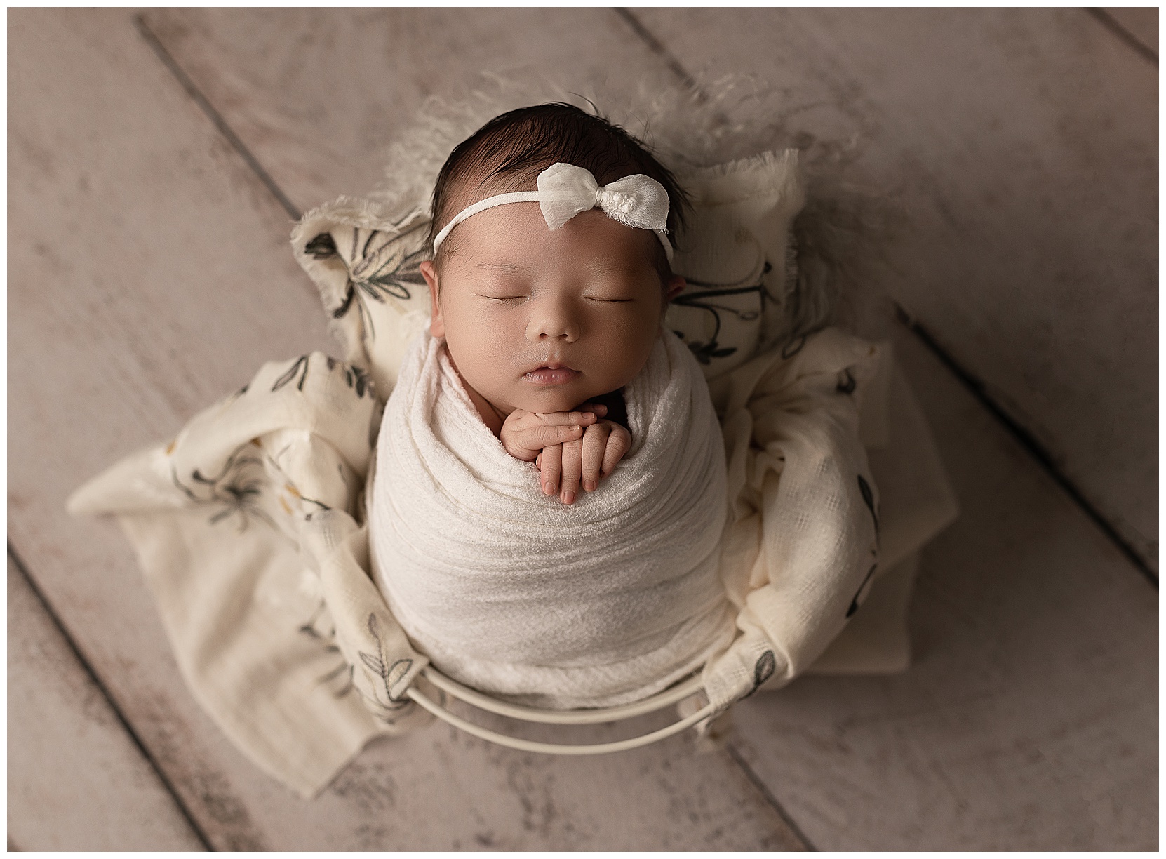 sleeping baby wrapped in white