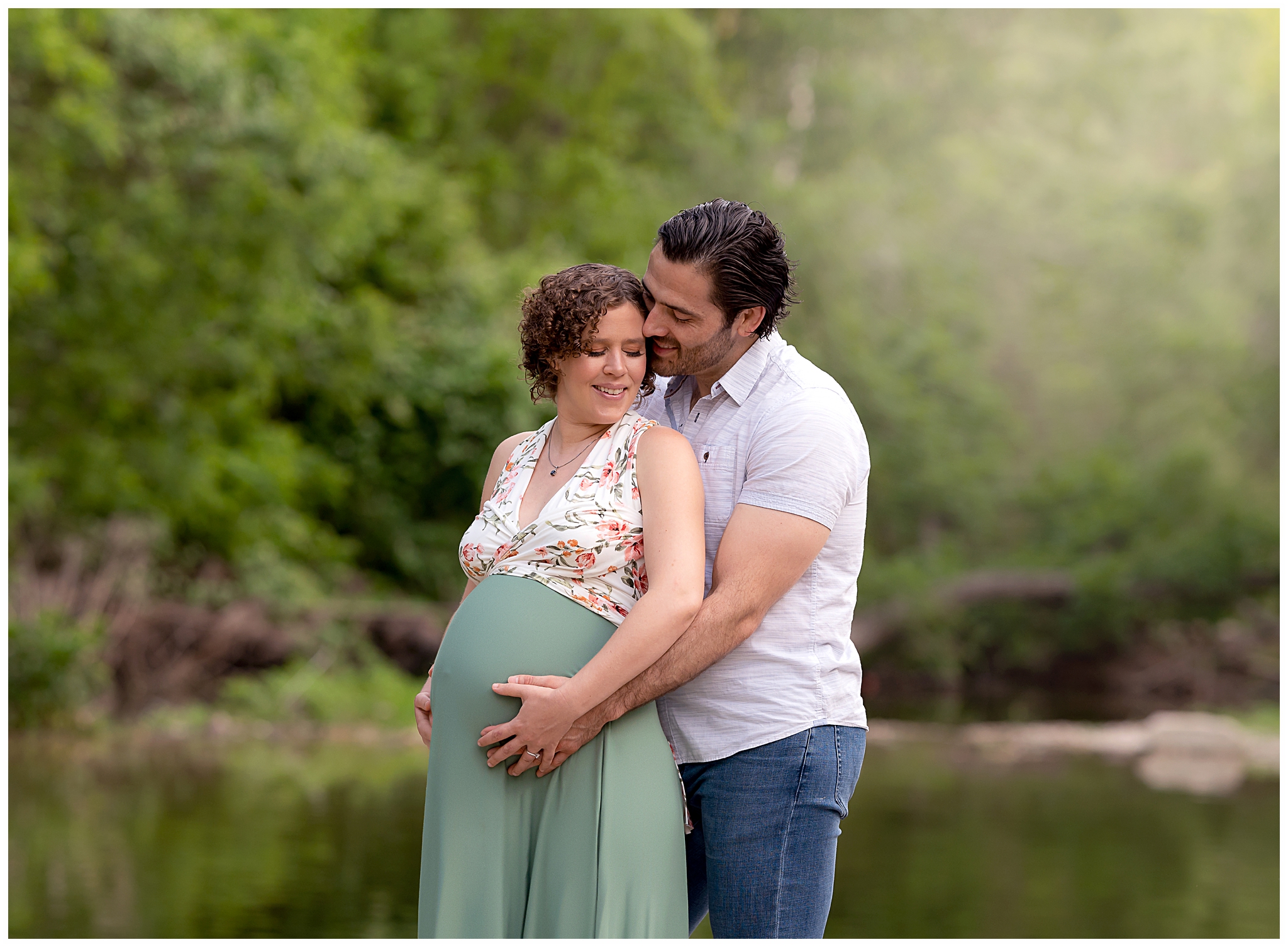 couple hugging holding pregnant belly green dress