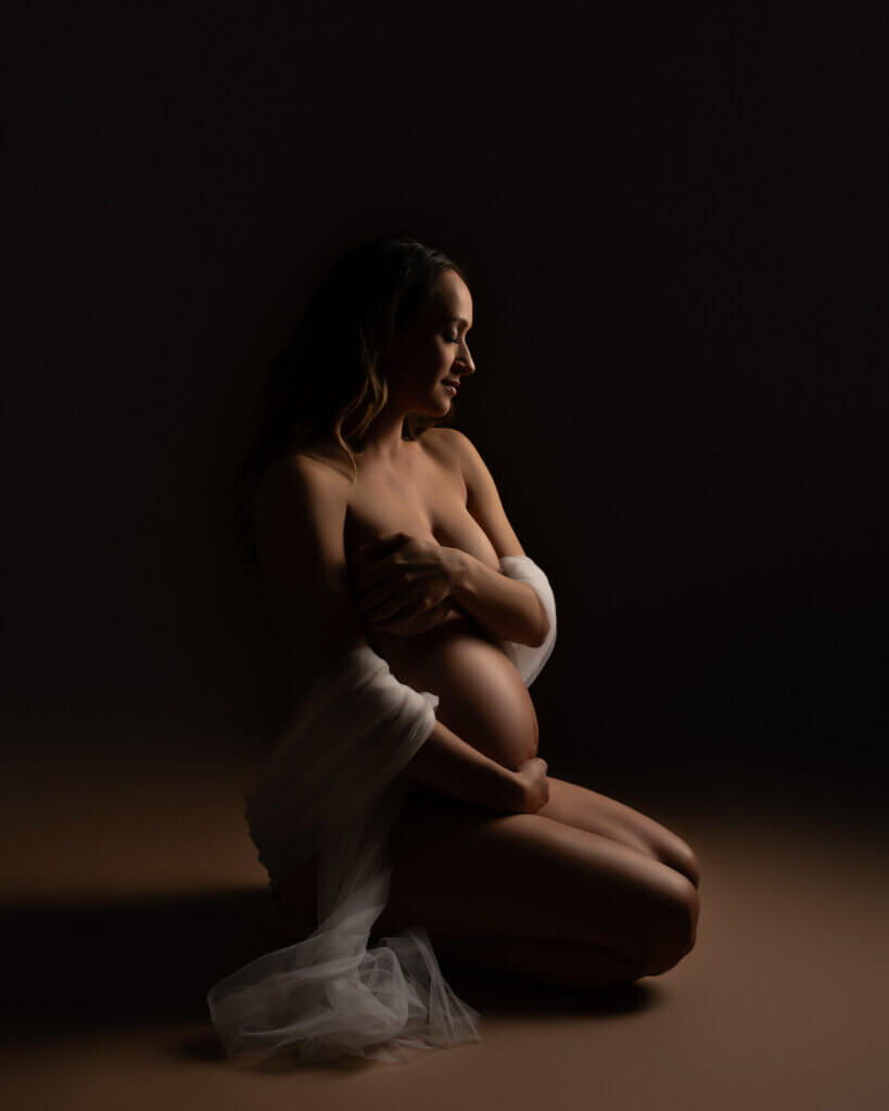 Dramatic lighting boudoir maternity portrait by Austin pregnancy photographer