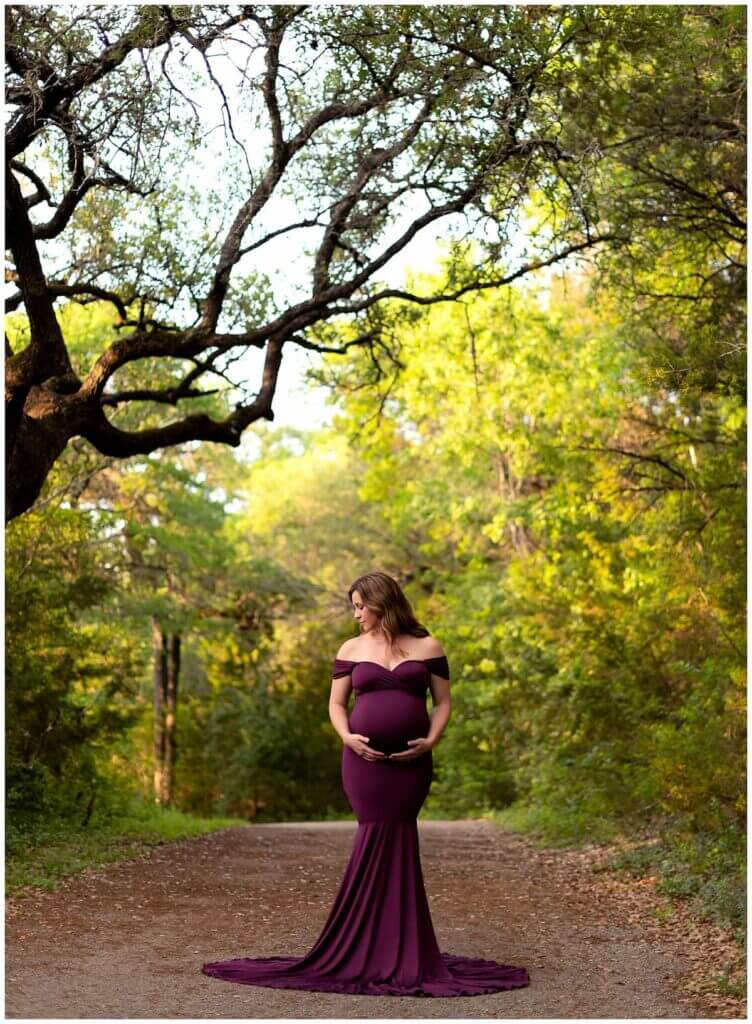 outdoor maternity photos woman wearing purple mermaid style maternity gown in cedar park, texas