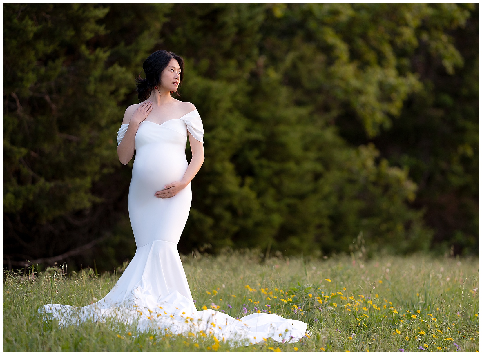 Brushy creek maternity photo featuring a woman in a white gown standing in a field of wildflowers