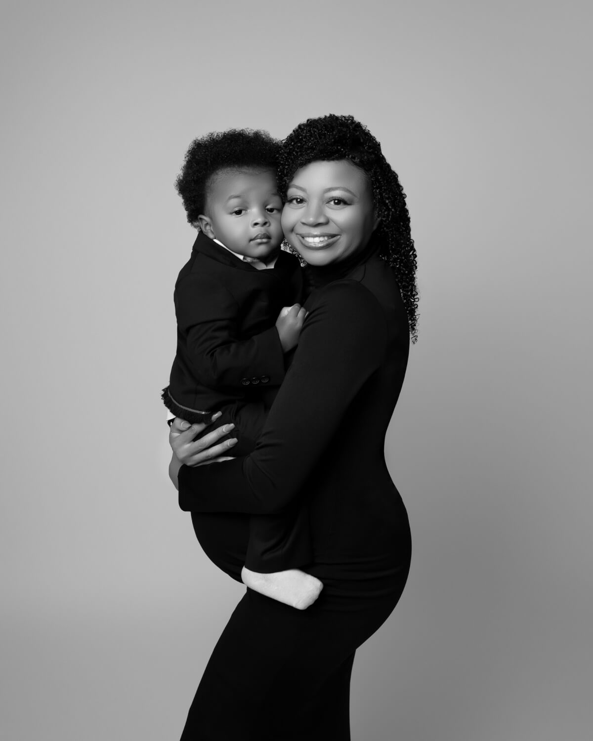 A mother holds her child to her cheek.