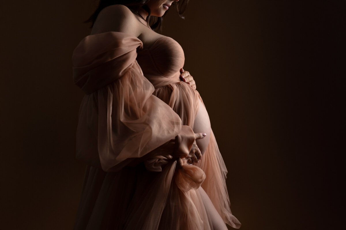 A close up shot of a pregnant woman's belly taken in a Cedar Park studio.