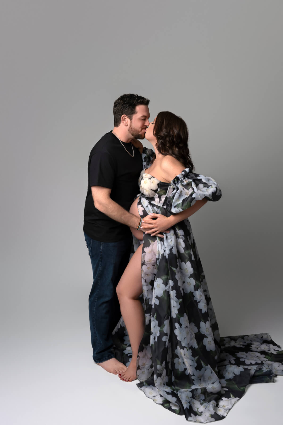 A man and a woman kiss each other in a Cedar Park photography studio.