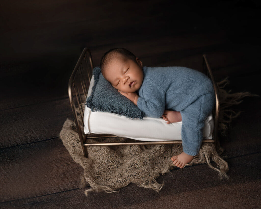 Perfect timing for newborn photos Austin showing peaceful sleeping baby during optimal session window