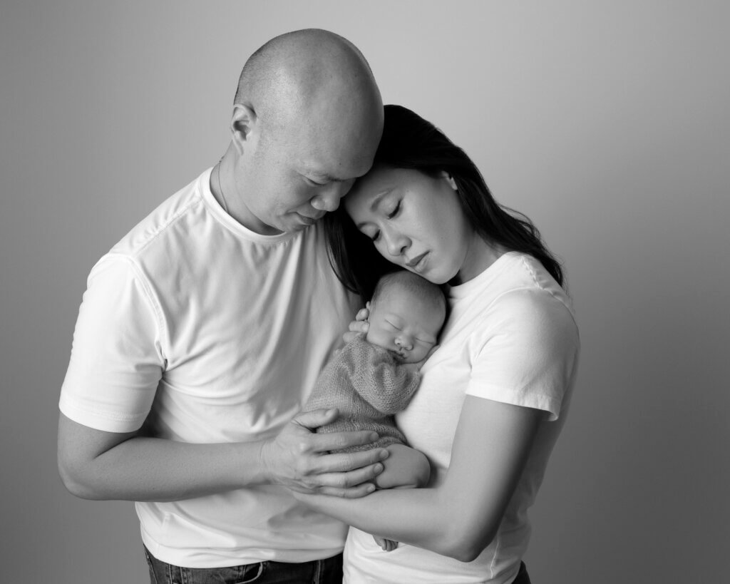 family with newborn baby in cozy portrait