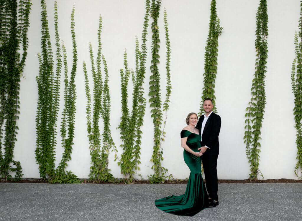 couple maternity photos Austin Central Library ivy wall downtown Austin Texas green gown