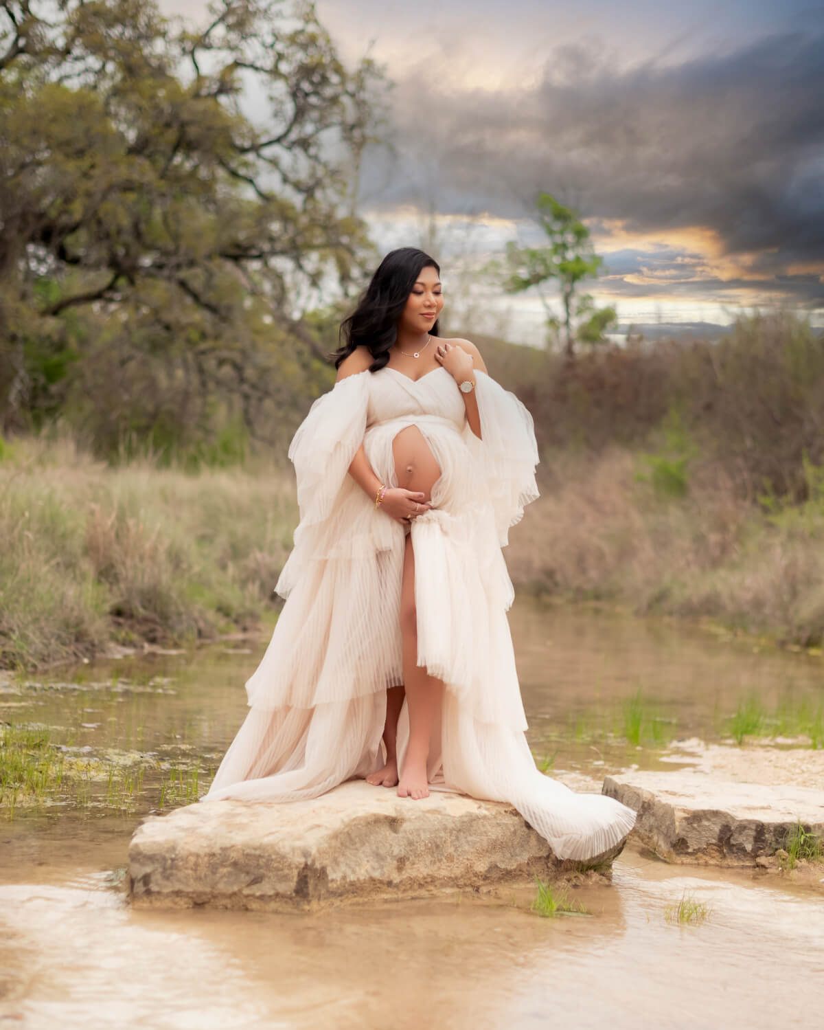 maternity photos Balcones Canyonlands Bertram TX woman in white gown on rock at sunset