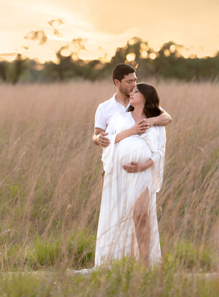 couple maternity photos at sunset Balcones Canyonlands Texas tall golden grasses white gown