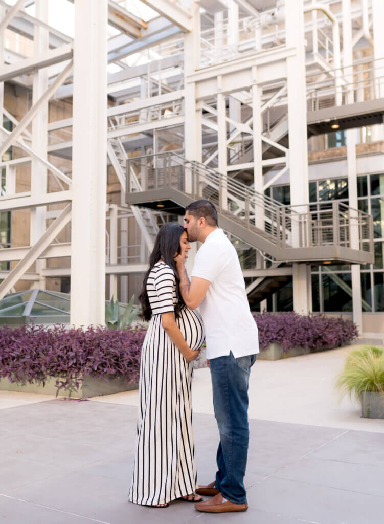couple maternity photos Seaholm district downtown Austin Texas casual modern architectural backdrop