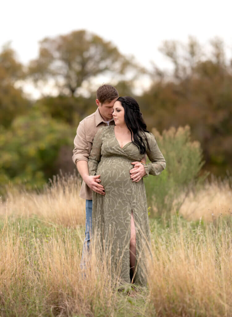 outdoor maternity session Cedar Park TX couple in tall golden grasses Brushy Creek