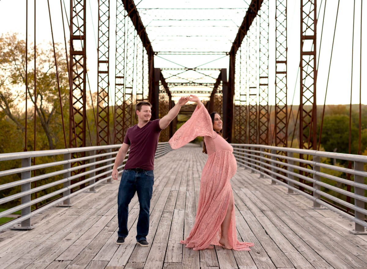 maternity photos on historic bridge Richard Moya Park Austin Texas pink flowy gown