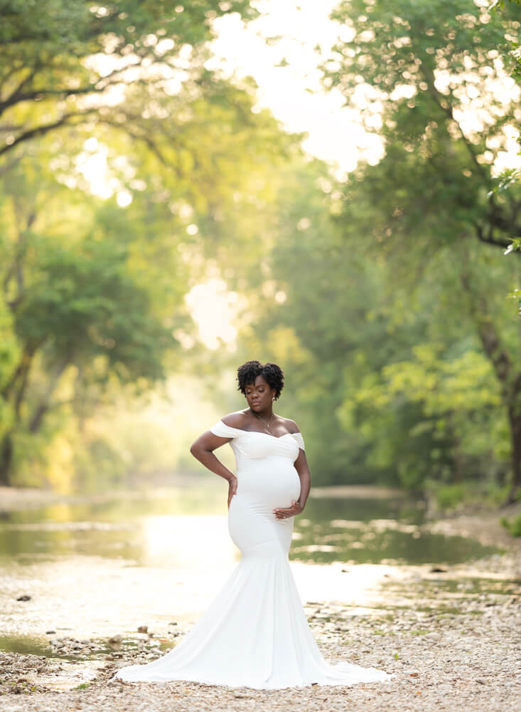 maternity photos at Richard Moya Park Austin Texas creek rocky area white gown