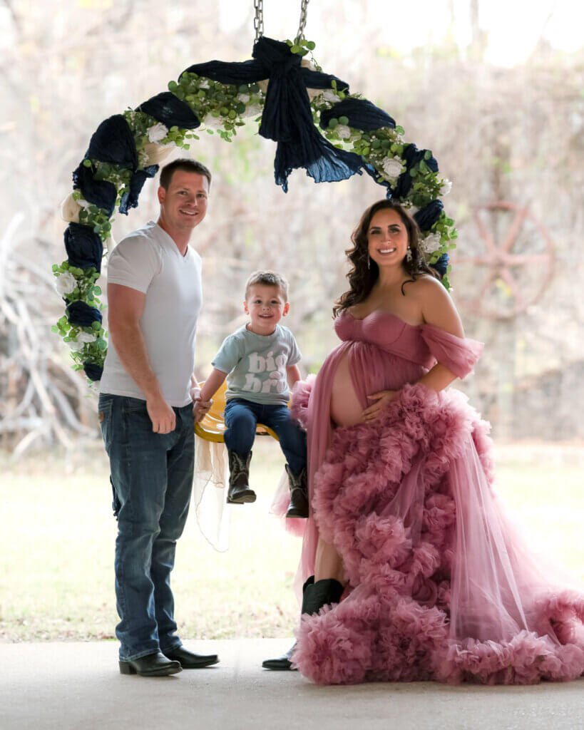 family maternity photos Sekrit Theater Austin Texas greenhouse floral arch purple gown