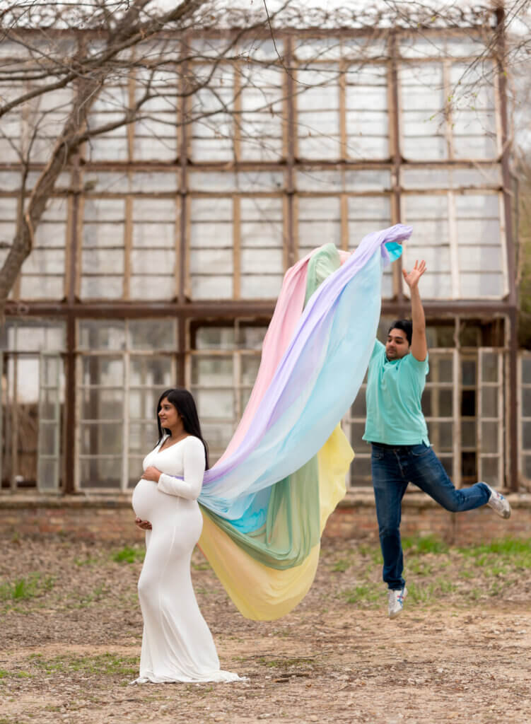 maternity photos outdoor grounds Sekrit Theater East Austin Texas white gown colorful backdrop