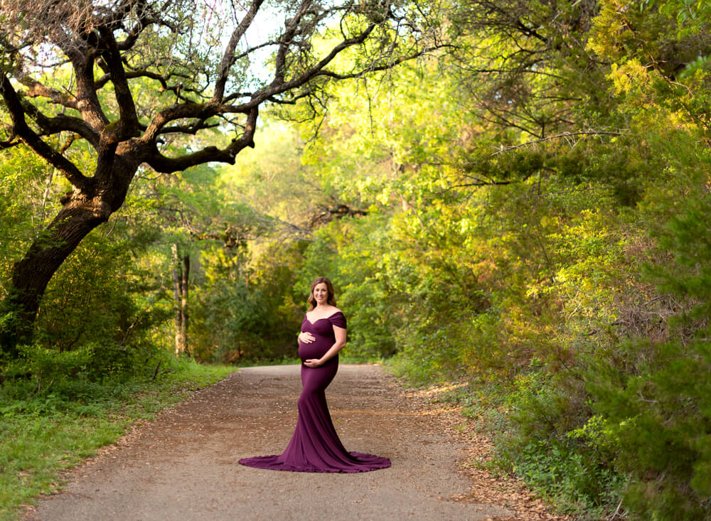 maternity session wooded canyon path Twin Creeks Historical Park Cedar Park Texas burgundy gown