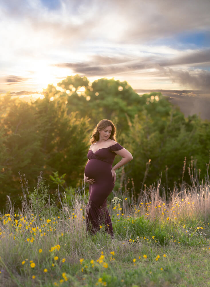 golden hour maternity photos Twin Creeks Historical Park Cedar Park Texas burgundy gown wildflowers